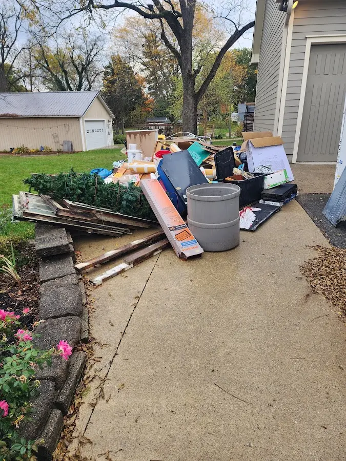 Dumpster being loaded with debris for Roofing Dumpster Rental in Kiskiminetas